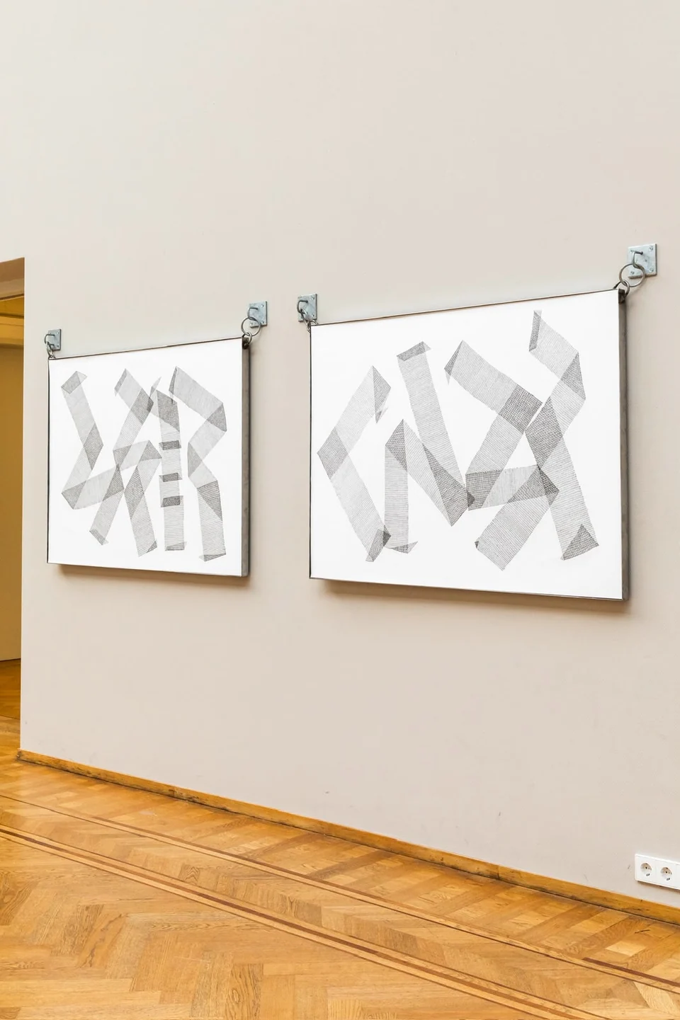 Two geometric drawings displayed together in a gallery