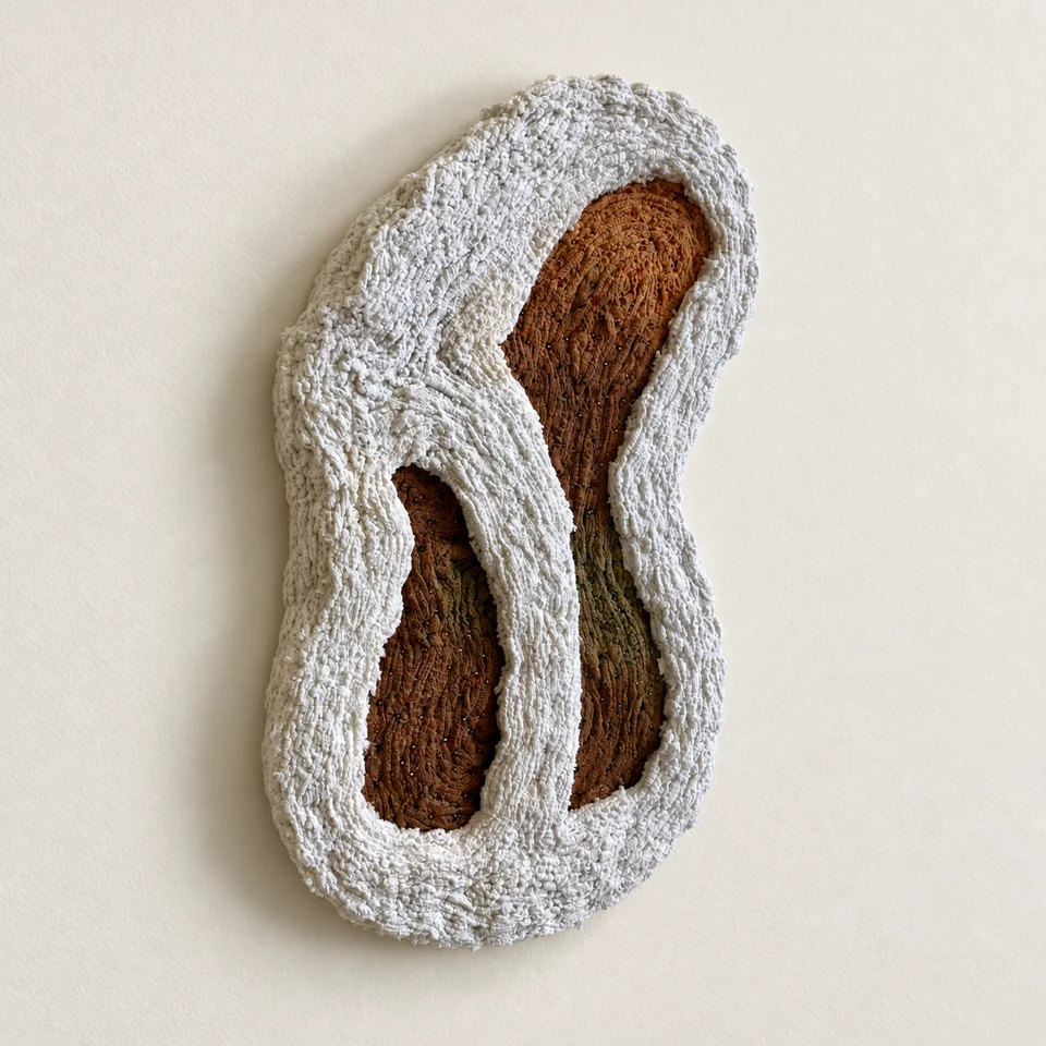 Organic white textile surrounding ochre and olive fibres